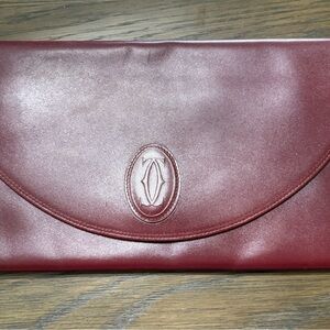 Cartier Red Clutch with Embossed Emblem and Curved Flap